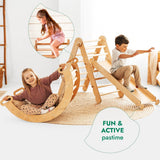 Children playing with wooden climbing toys in a room with a white wall.