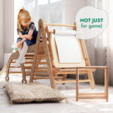 Child playing on a wooden climbing toy with a pillow on the floor.