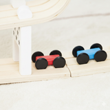 Colorful dumbbell-shaped objects on a wooden surface