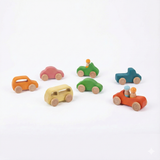 Set of colorful wooden toy cars on a white background