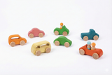 Set of colorful wooden toy cars on a white background