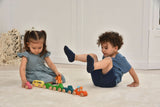 Two children playing with colorful wooden toys on a light-colored floor.