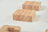 Wooden blocks with '1.1 one' text on a white background