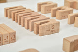 Wooden blocks with numbers and letters on a white surface