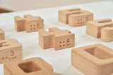Wooden blocks with numbers on a white surface