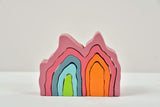 Stack of colorful wooden toys on a light gray background
