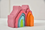 Set of colorful foam blocks stacked on a white surface with a light gray background