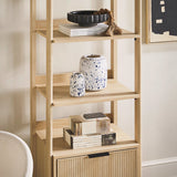 Wooden shelf with decorative items against a neutral wall
