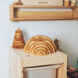 Wooden toys on a shelf with a focus on educational items