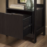 Black bookshelf with open drawer, books, and a vase on top.