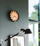 Black Wall Clock on wall by Yamazaki Home.