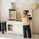 Child pretending to cook with play kitchen set