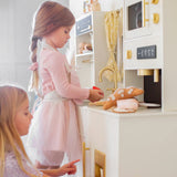 Children playing with play kitchen set