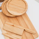 Set of wooden cutting boards and knives on a white background